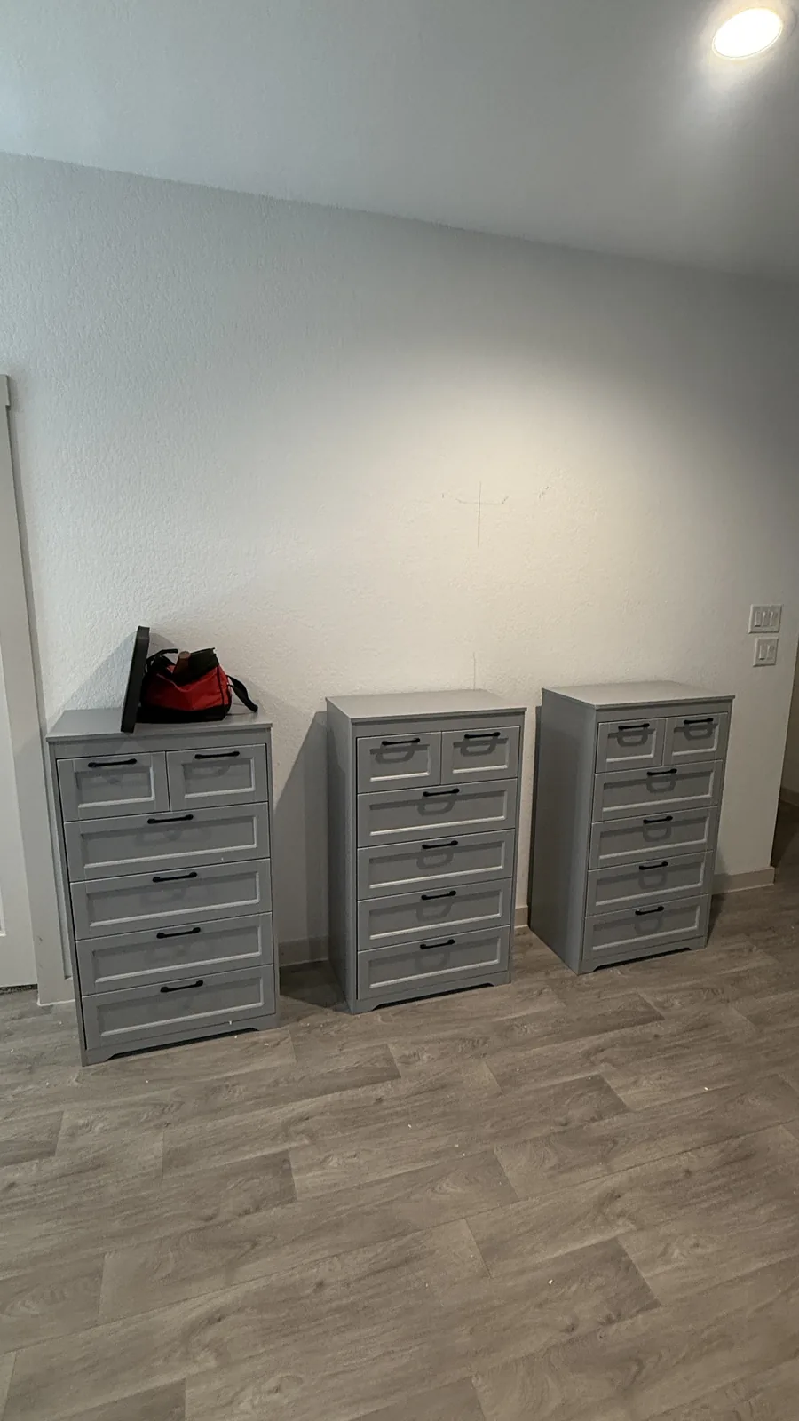 Three dressers assembled in a Houston-area bedroom