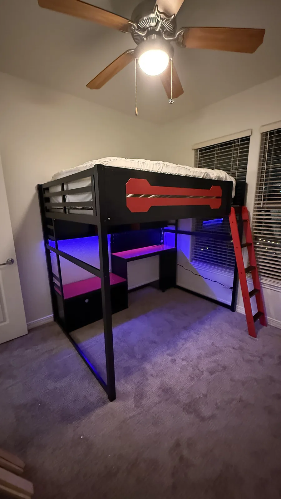 Loft bed with built-in desk assembled in a Houston-area kids room