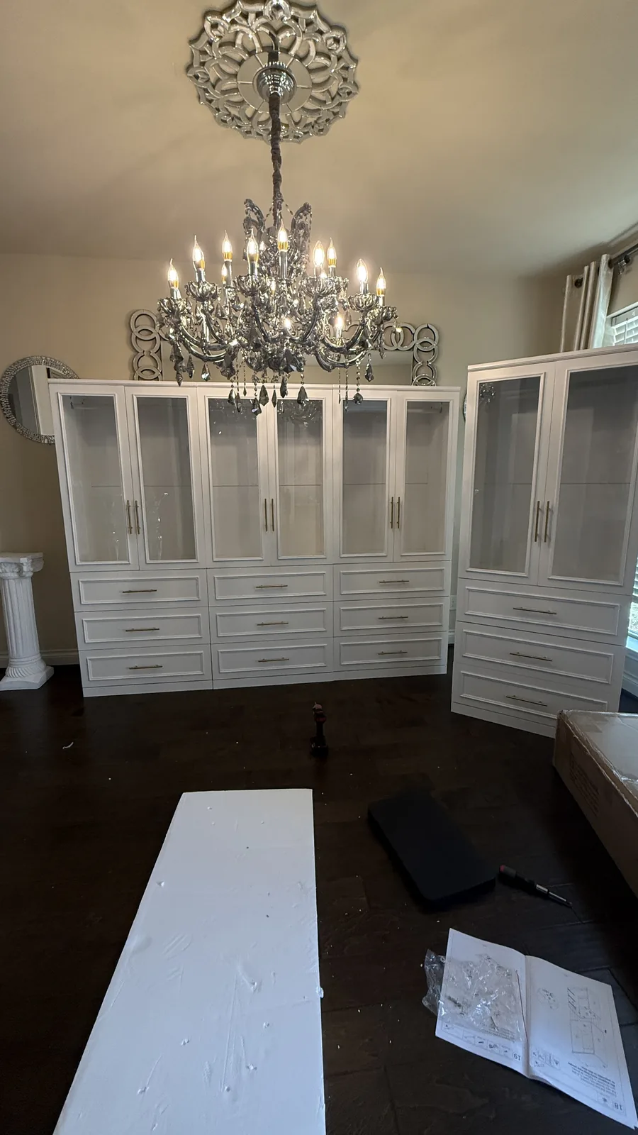 White wardrobe and closet system assembled in a Houston-area home
